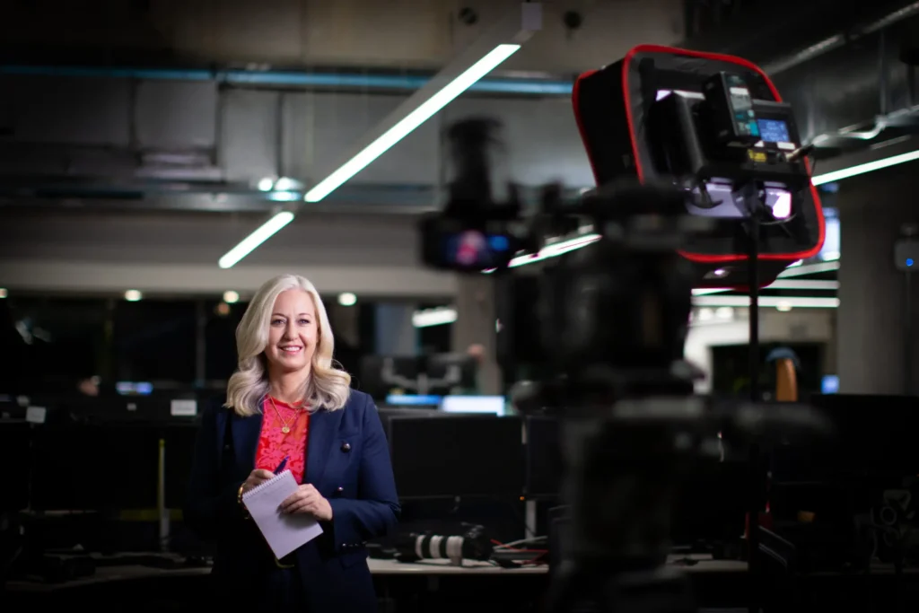 Media consultant leading an early-stage story workshopping session in a newsroom, helping clients refine their campaign narrative.