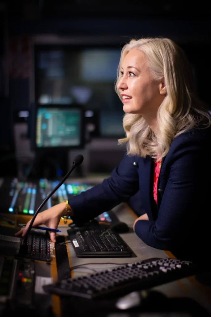 Erica Wood guiding a media training session from a broadcast control room, helping professionals transform their media presence with confidence.